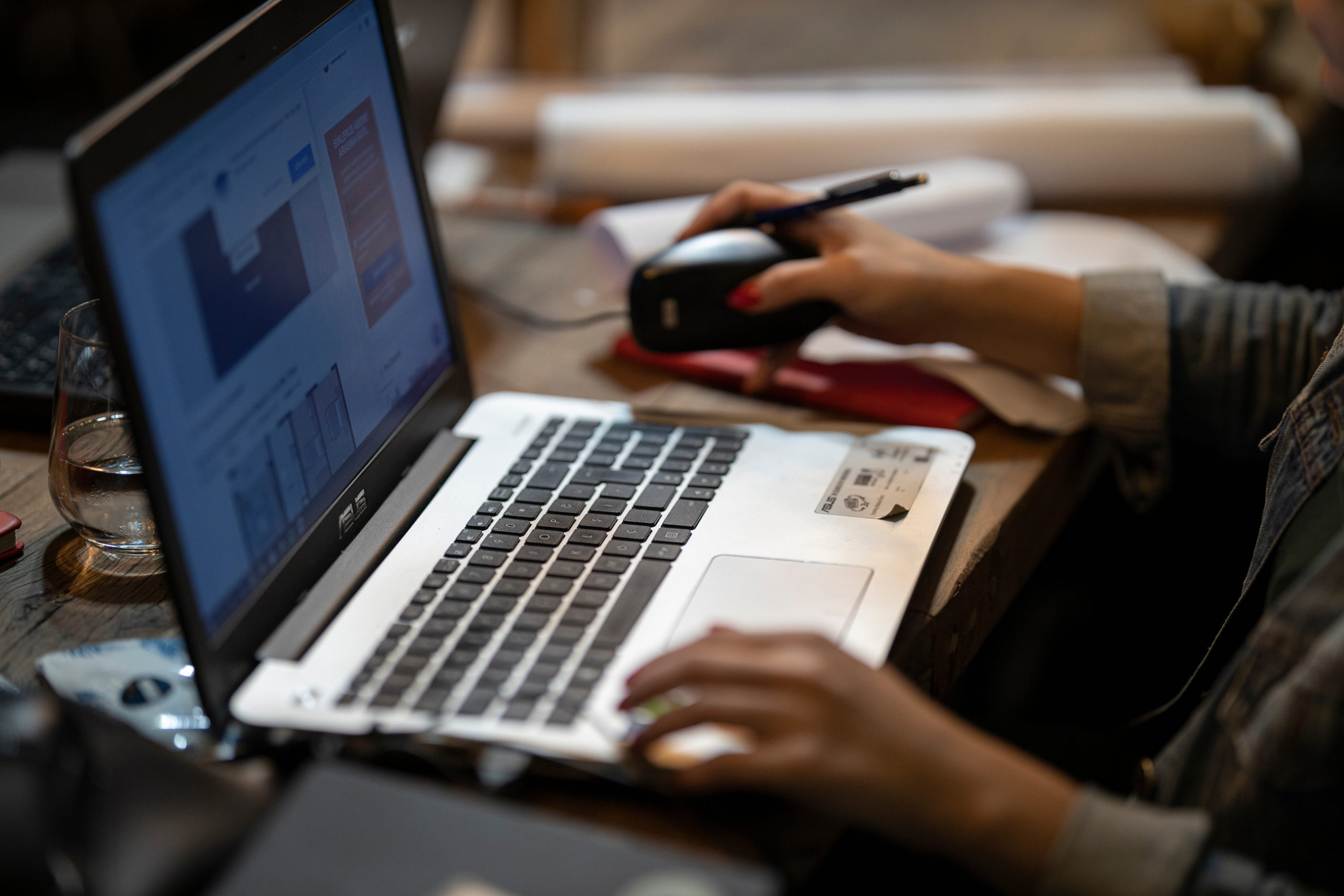 Hands working on a laptop