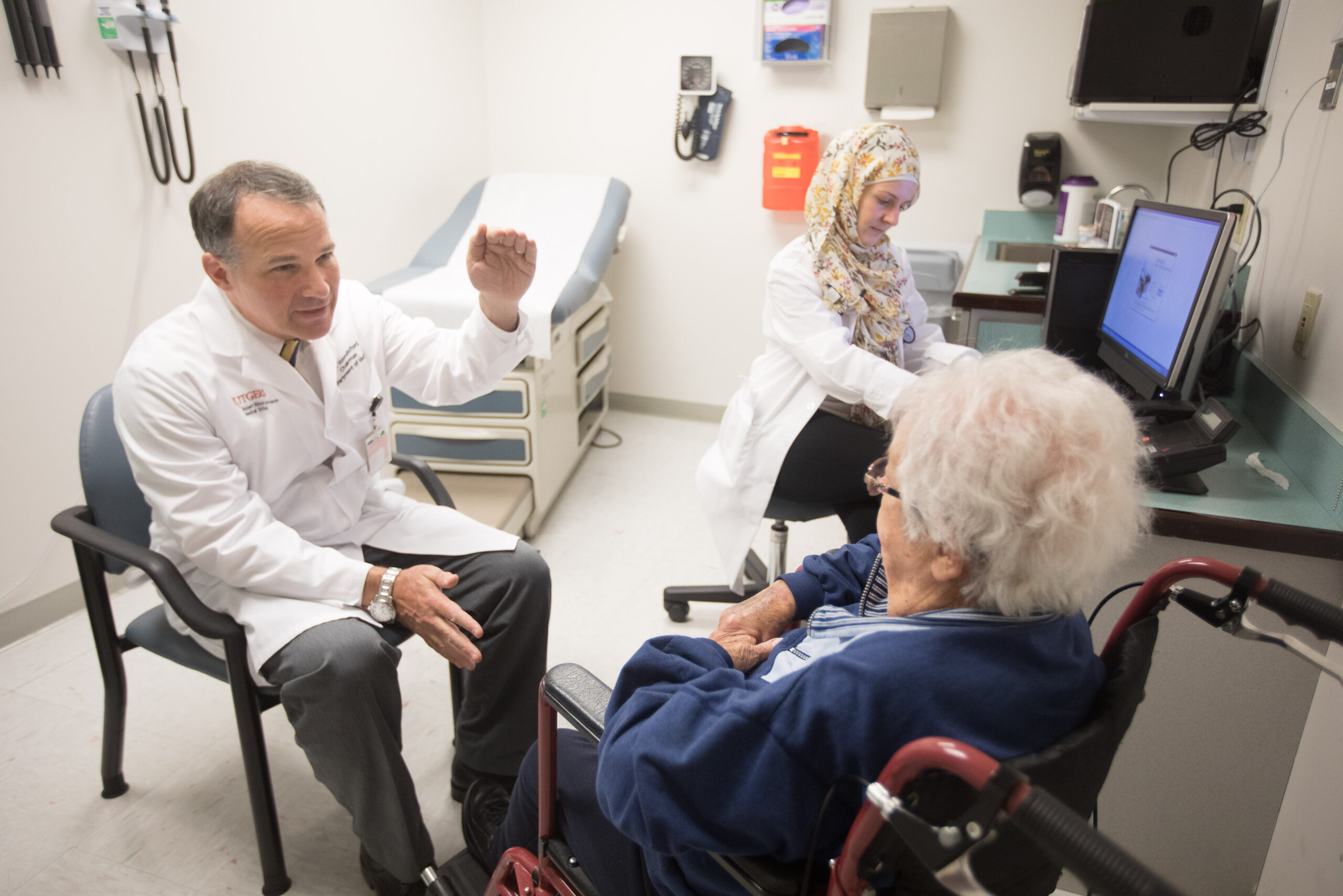Professor, Chairman of Medicine and Chancellor Scholar, Rutgers-Robert Wood Johnson School of Medicine Fredric E. Wondisford, MD meets with patient Shirley Brick Cardiology Fellow Juman Takeddin takes notes